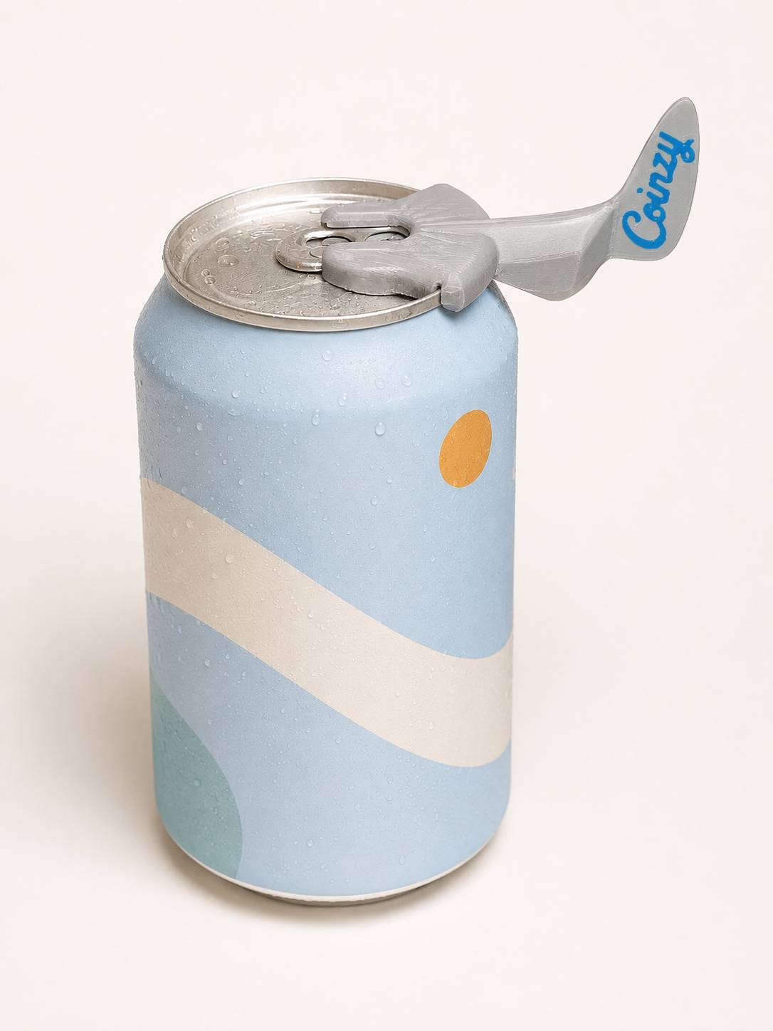 Close-up of Coinzy clipped securely onto the rim of a beverage can